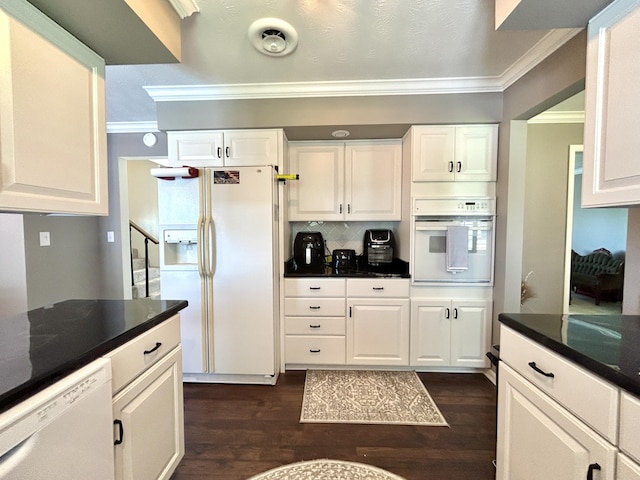 kitchen with dark wood finished floors, dark countertops, white appliances, and crown molding