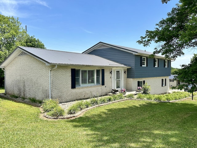 split level home with a front lawn and brick siding