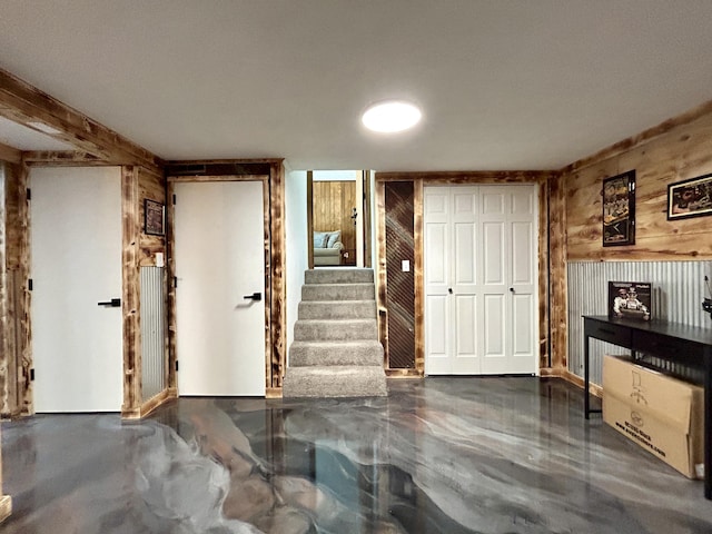 entryway featuring wood walls and stairway