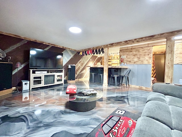 living room with marble finish floor and wooden walls