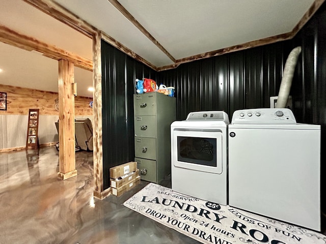 washroom with laundry area, independent washer and dryer, and wooden walls