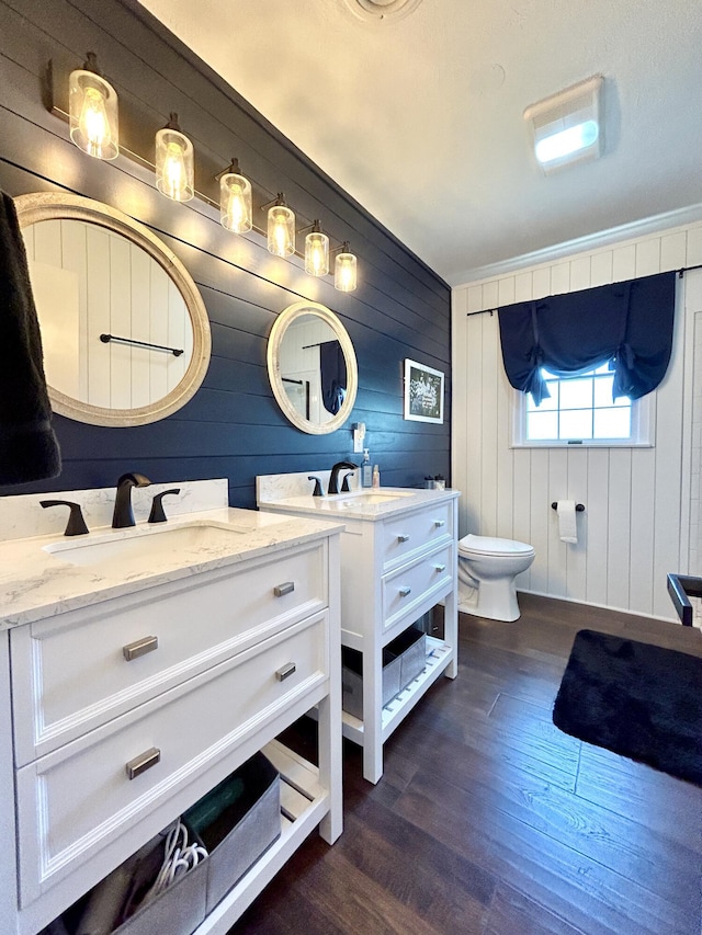 full bath with vanity, toilet, and wood finished floors