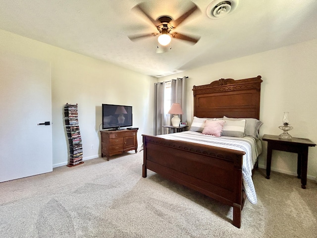 bedroom featuring light carpet, baseboards, visible vents, and a ceiling fan