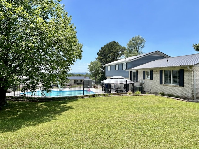 view of yard featuring a fenced in pool, fence, cooling unit, and a gazebo