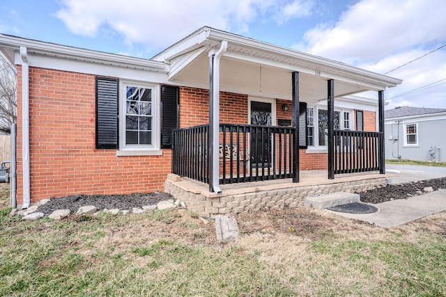 view of front of property with a porch and brick siding