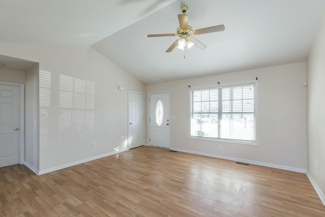 foyer with vaulted ceiling, light wood-type flooring, visible vents, and a ceiling fan