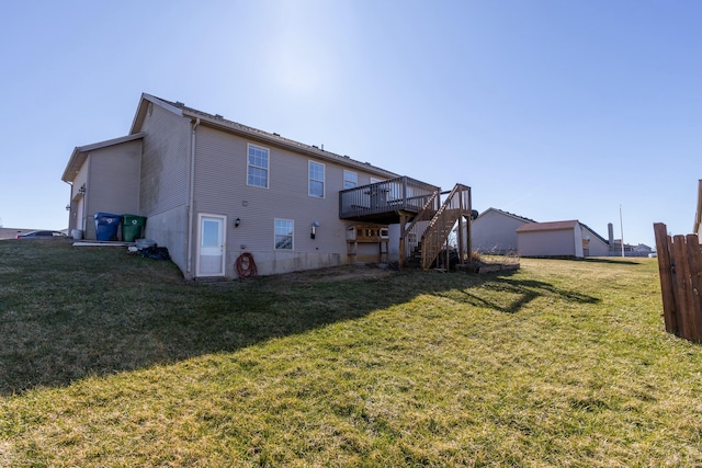 rear view of property with stairs, a lawn, and a wooden deck