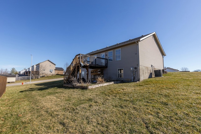 rear view of house with stairs, a deck, central AC, and a yard