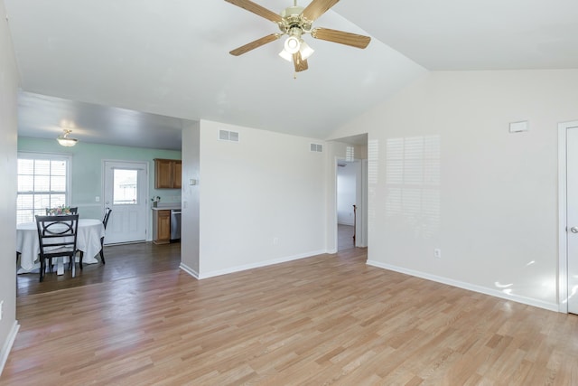 unfurnished living room featuring baseboards, visible vents, and light wood finished floors