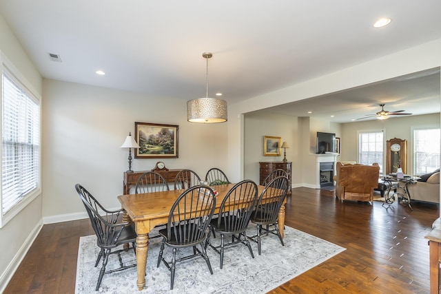 dining room featuring recessed lighting, visible vents, dark wood-type flooring, and a fireplace