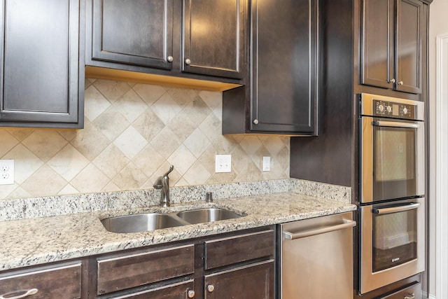 kitchen featuring a sink, stainless steel appliances, and dark brown cabinetry