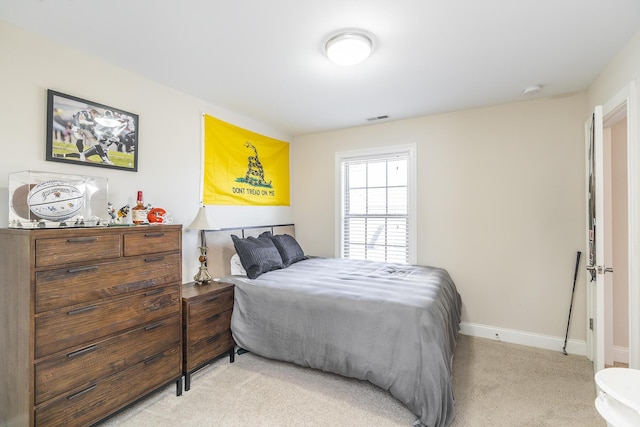 carpeted bedroom featuring visible vents and baseboards