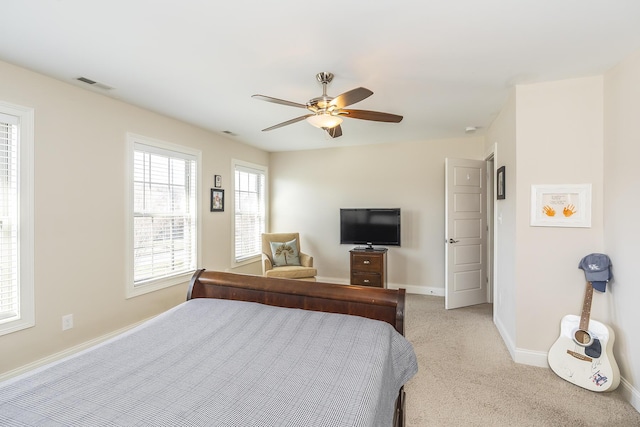 bedroom featuring visible vents, baseboards, light colored carpet, and ceiling fan