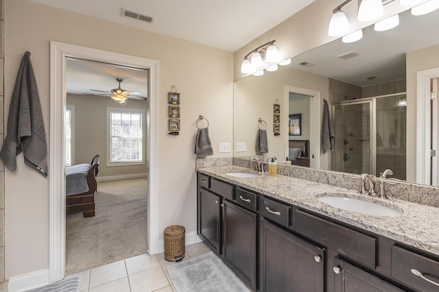 full bathroom featuring a shower stall, visible vents, and a sink