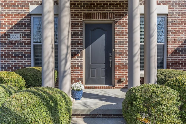 property entrance with brick siding