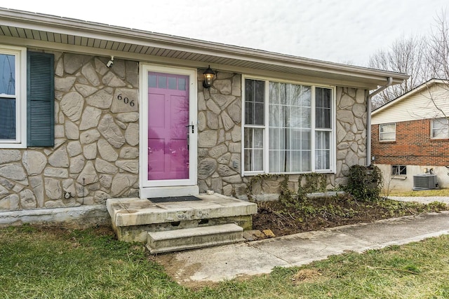 doorway to property featuring stone siding