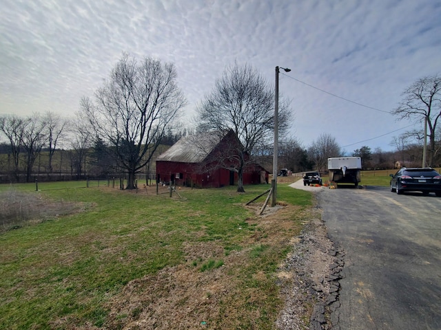 view of road with a barn