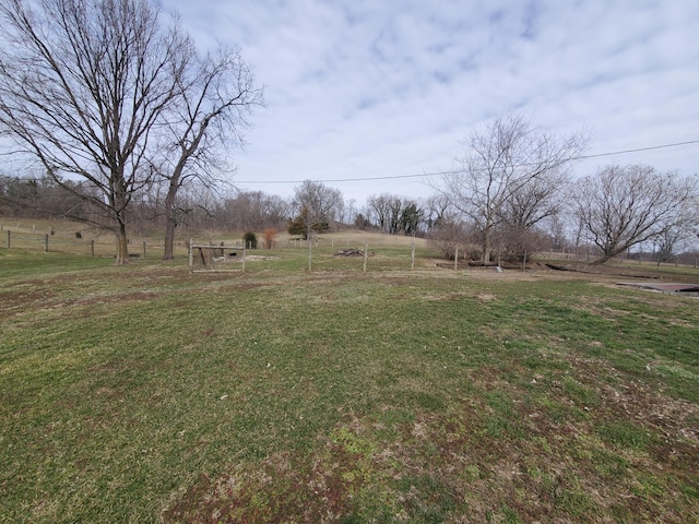 view of yard featuring a rural view and fence