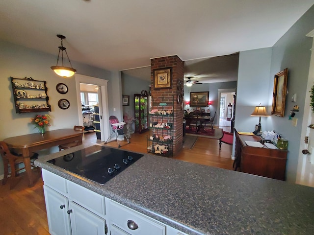 kitchen featuring pendant lighting, black electric stovetop, white cabinetry, ceiling fan, and wood finished floors