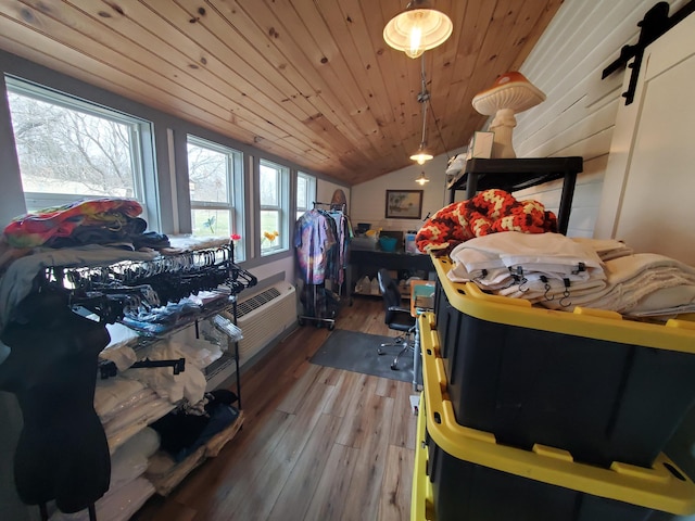 bedroom with vaulted ceiling, wood finished floors, and wood ceiling