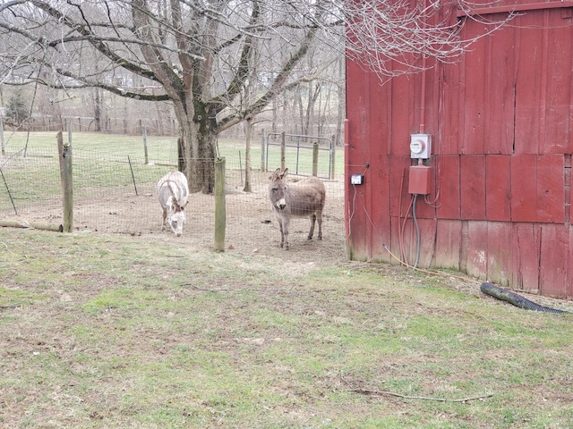 view of yard with an outbuilding and fence