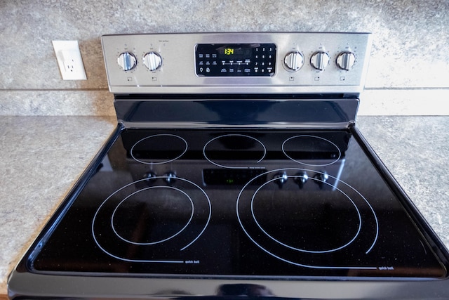 room details with stainless steel electric range oven and mail area