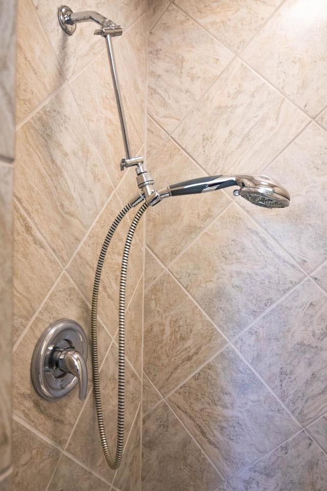 interior details with a tile shower