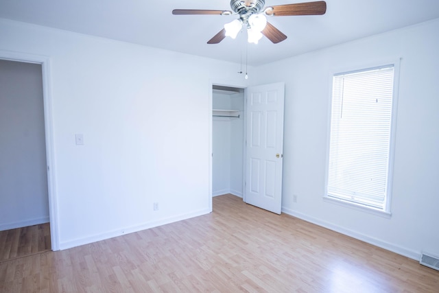 unfurnished bedroom with a ceiling fan, a closet, baseboards, and wood finished floors