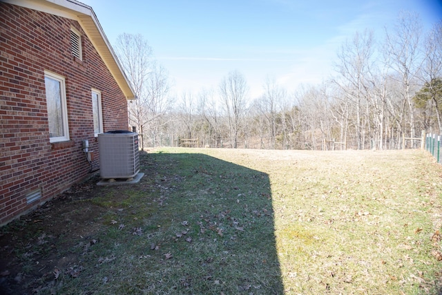 view of yard with fence and central AC unit