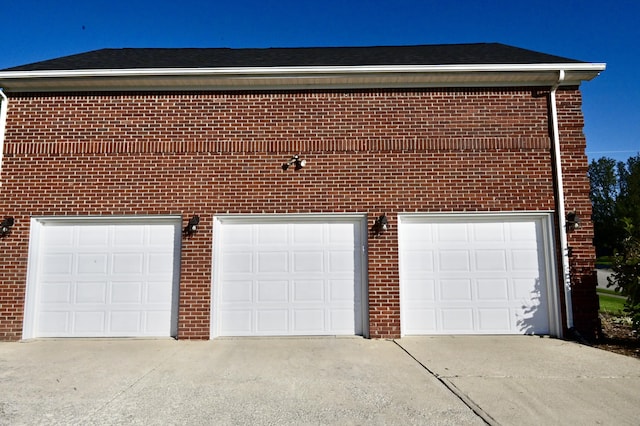 garage featuring concrete driveway