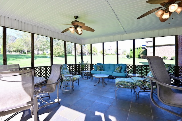 sunroom / solarium featuring ceiling fan and a healthy amount of sunlight