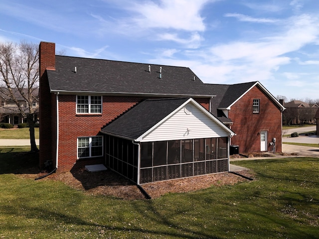 415 David Ln, Winchester, KY 40391 - back of house with a sunroom, a chimney, a lawn, and brick siding