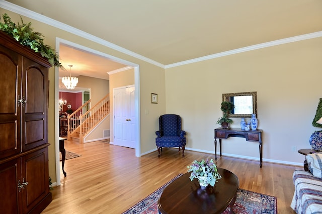 living room with a notable chandelier, baseboards, stairway, light wood finished floors, and crown molding