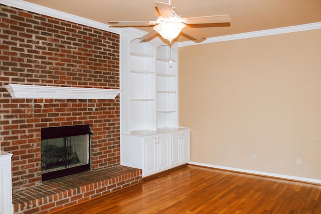 415 David Ln, Winchester, KY 40391 - unfurnished living room with ornamental molding, a ceiling fan, wood finished floors, and a brick fireplace