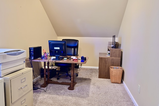 carpeted office space with vaulted ceiling and baseboards