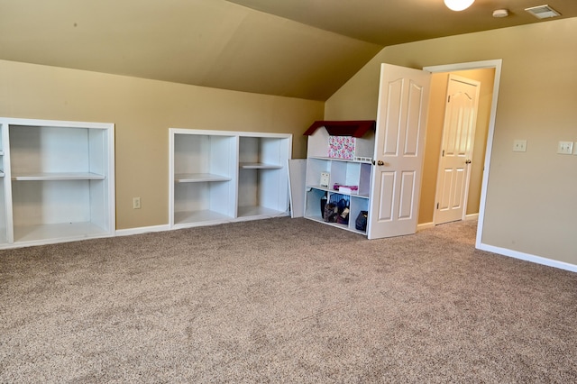 unfurnished bedroom featuring carpet floors, visible vents, vaulted ceiling, and baseboards