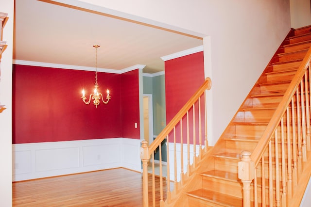 415 David Ln, Winchester, KY 40391 - stairs with crown molding, wood finished floors, a chandelier, and wainscoting