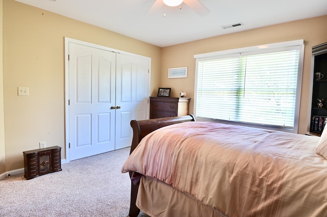 bedroom featuring baseboards, visible vents, ceiling fan, carpet flooring, and a closet