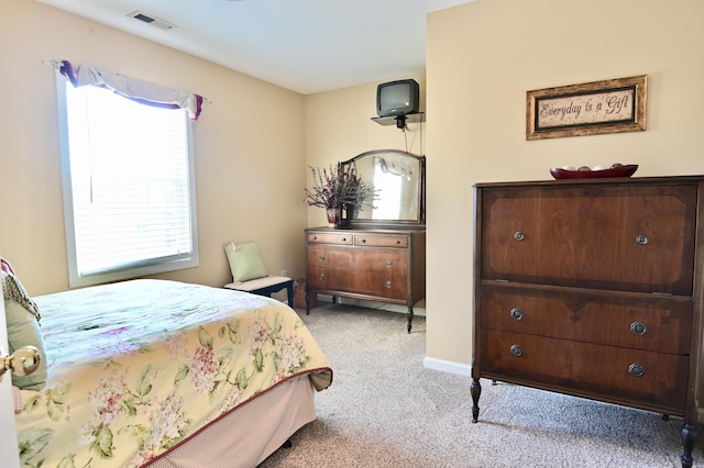 carpeted bedroom featuring visible vents and baseboards