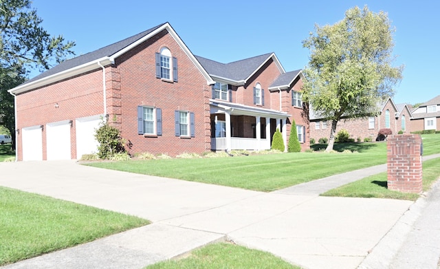 view of front of house with driveway, a front lawn, and brick siding