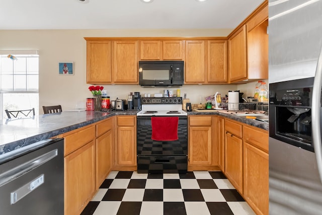 kitchen featuring a peninsula, light floors, and appliances with stainless steel finishes