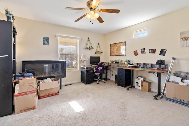 carpeted home office featuring a ceiling fan and baseboards