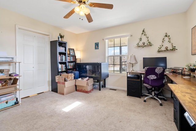 office space with ceiling fan, carpet floors, and baseboards