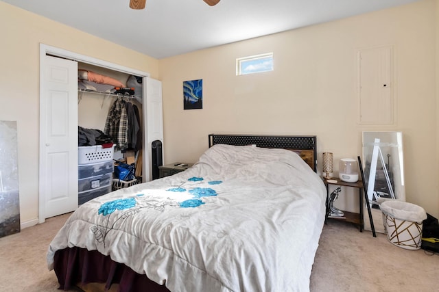 bedroom with carpet floors, electric panel, a ceiling fan, and a closet