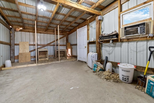 miscellaneous room with cooling unit, unfinished concrete flooring, and metal wall