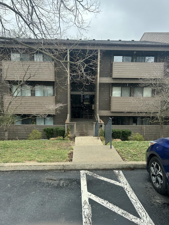 view of property featuring uncovered parking