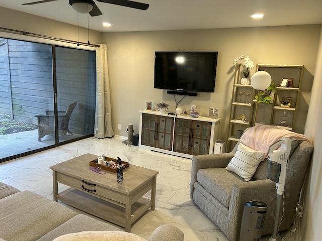 living area with recessed lighting, marble finish floor, ceiling fan, and baseboards