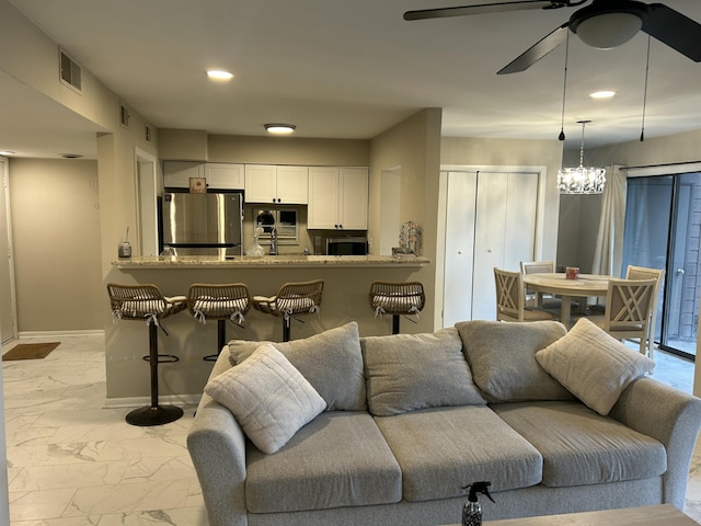 living room with marble finish floor, recessed lighting, visible vents, ceiling fan, and baseboards