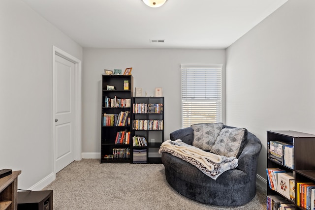 sitting room with visible vents, baseboards, and carpet floors