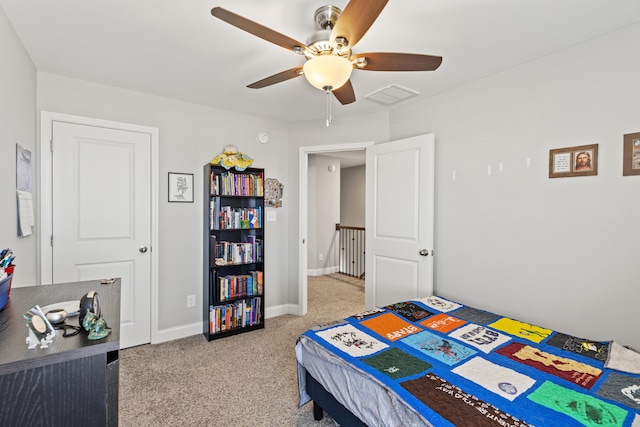 bedroom with visible vents, light colored carpet, baseboards, and ceiling fan